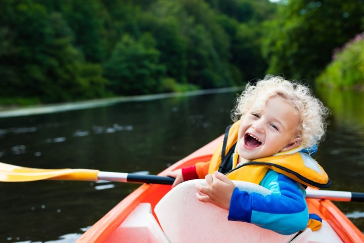 smiling boy in a kayak